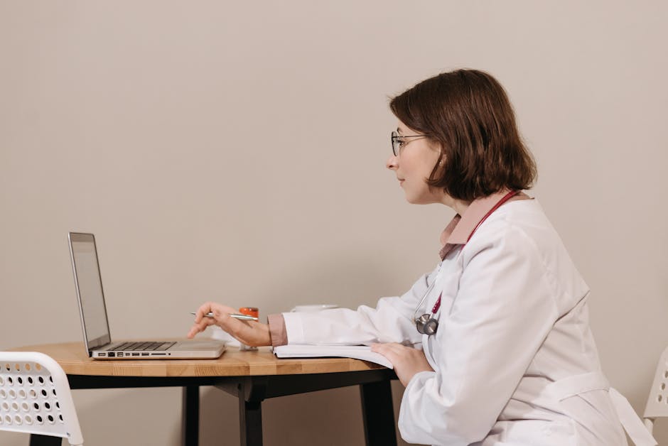 Doctor using MedicoPlus Ayur software on laptop for clinical notes