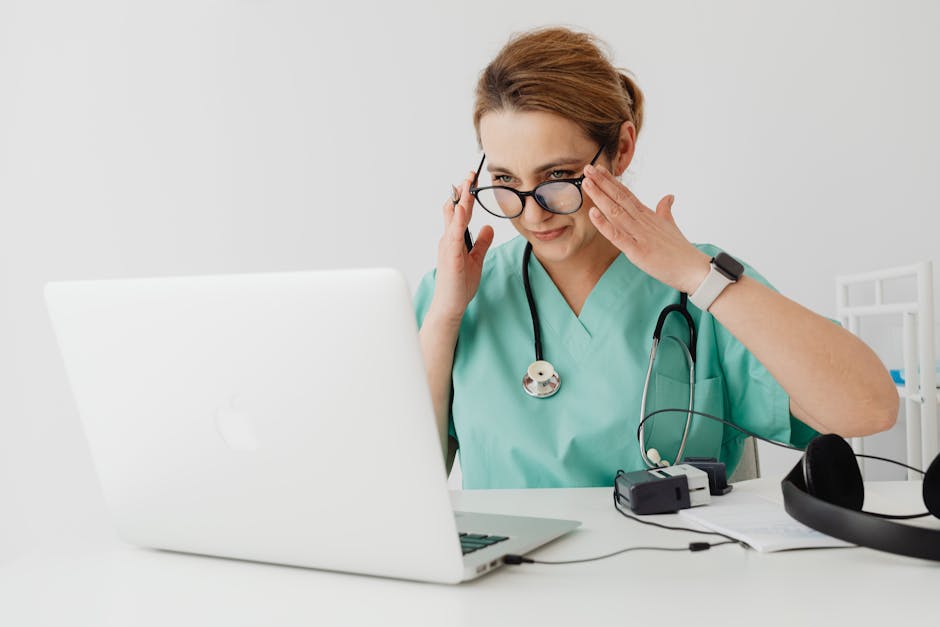 Nurse using MedicoPlus Ayur software on laptop at an Ayurvedic clinic