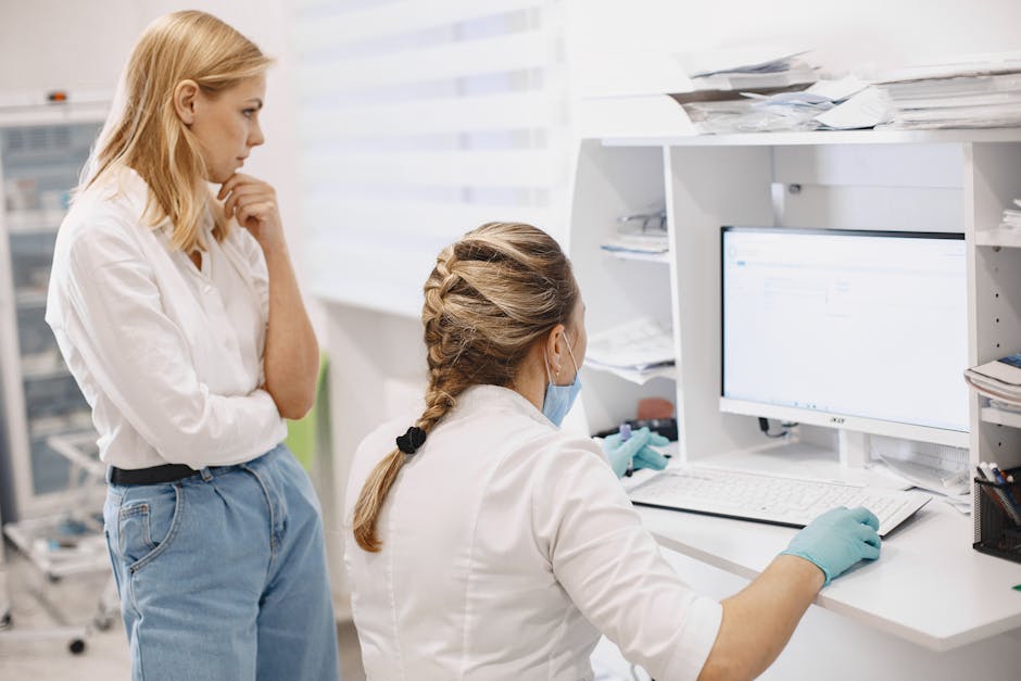 Nurses using MedicoPlus Ayur software at computer workstation